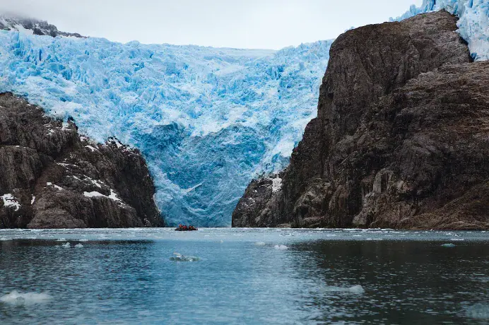 A tidewater glacier meeting the sea in a Patagonian fjord