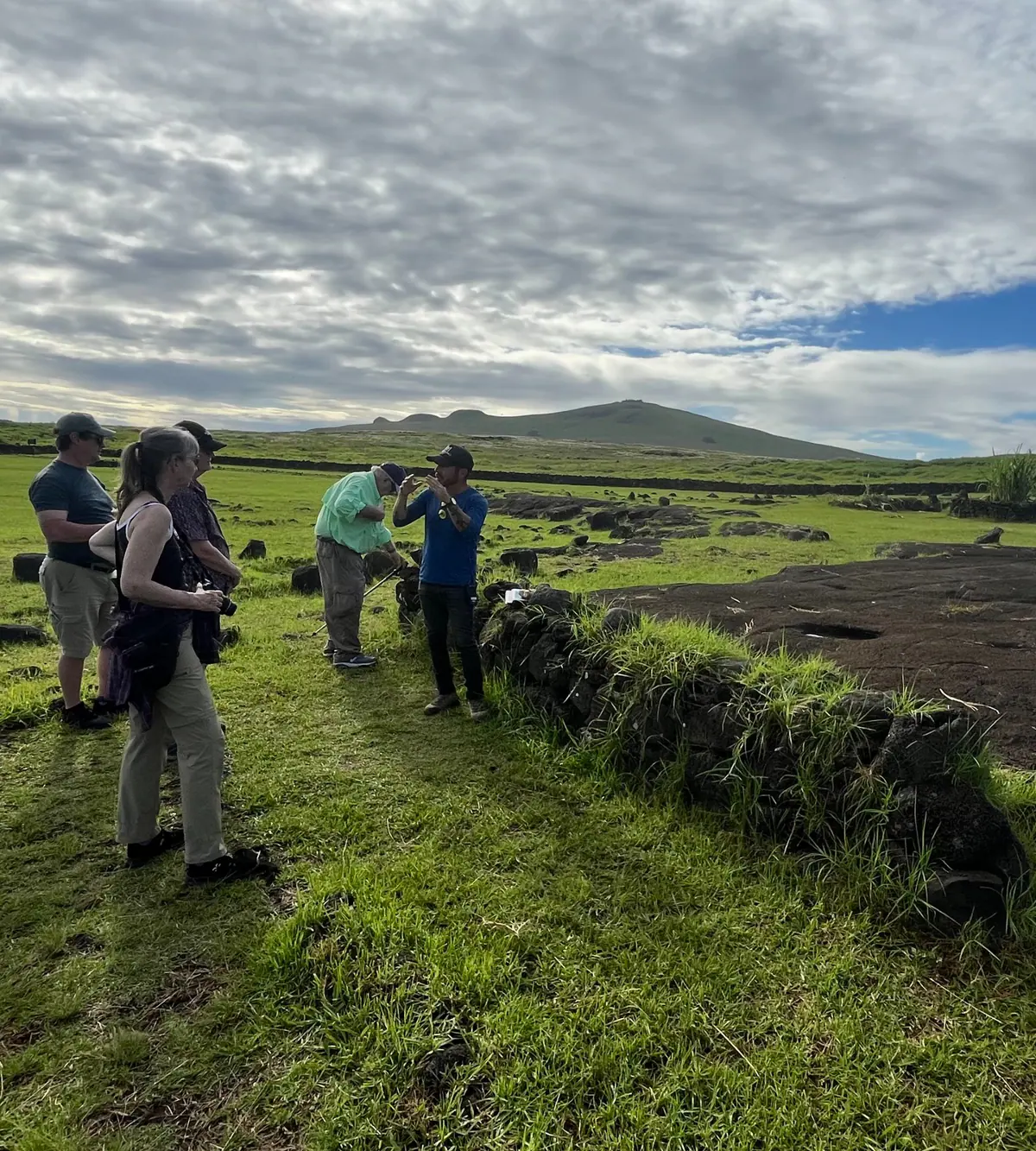 A small group walking the green hills of Rapa Nui