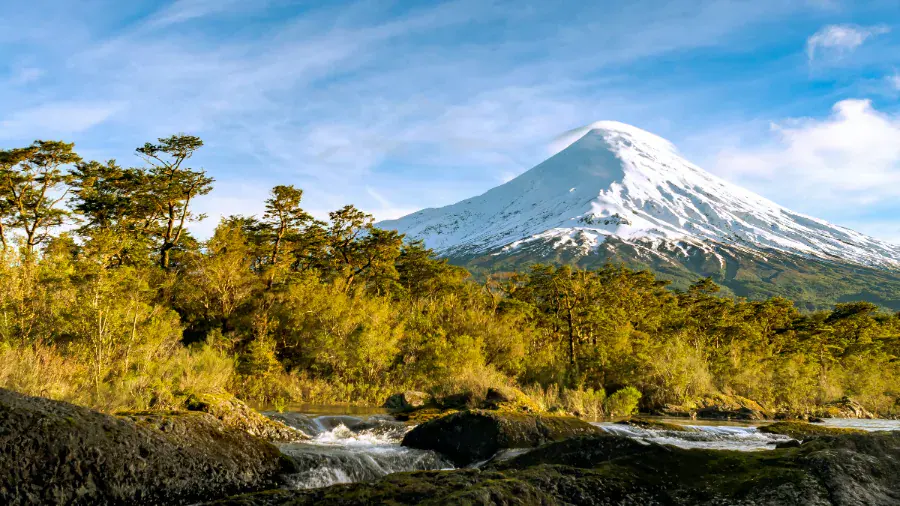 Osorno Volcano rising above forest and river